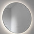 Round illuminated wall mirror on a plain background