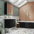 Modern bathroom with black vanity, shower enclosure, and skylight.