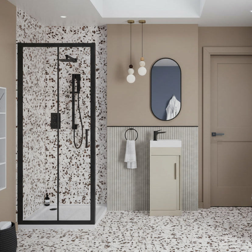 Modern bathroom with terrazzo flooring, shower, sink, and toilet.