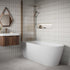 Modern bathroom with freestanding bathtub, walnut fluted wooden vanity, and tiled walls.