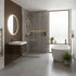 Modern bathroom with a freestanding bathtub, sink, and mirrors.