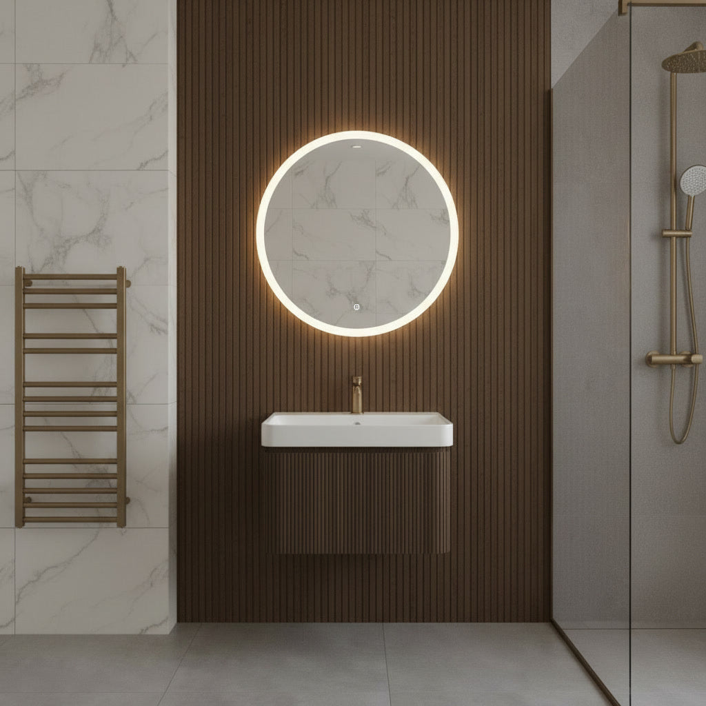 Modern bathroom interior with a round illuminated mirror and fluted wall-mounted walnut vanity unit & sink.