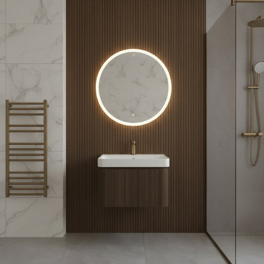 Modern bathroom interior with a round illuminated mirror and fluted wall-mounted walnut vanity unit & sink.