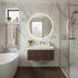 Modern bathroom with marble walls, a freestanding bathtub, and a walnut fluted vanity with a round mirror.