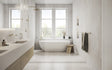 Modern bathroom with a freestanding bathtub, sink, and towel rack.