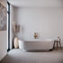 Modern bathroom with a freestanding bathtub, decorative vase, and small table.