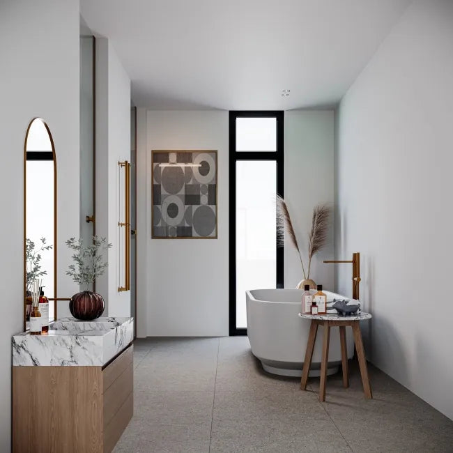 Modern bathroom with freestanding bathtub, vanity, and decorative elements.