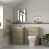 Bathroom with wooden vanity, toilet, and decorative elements.