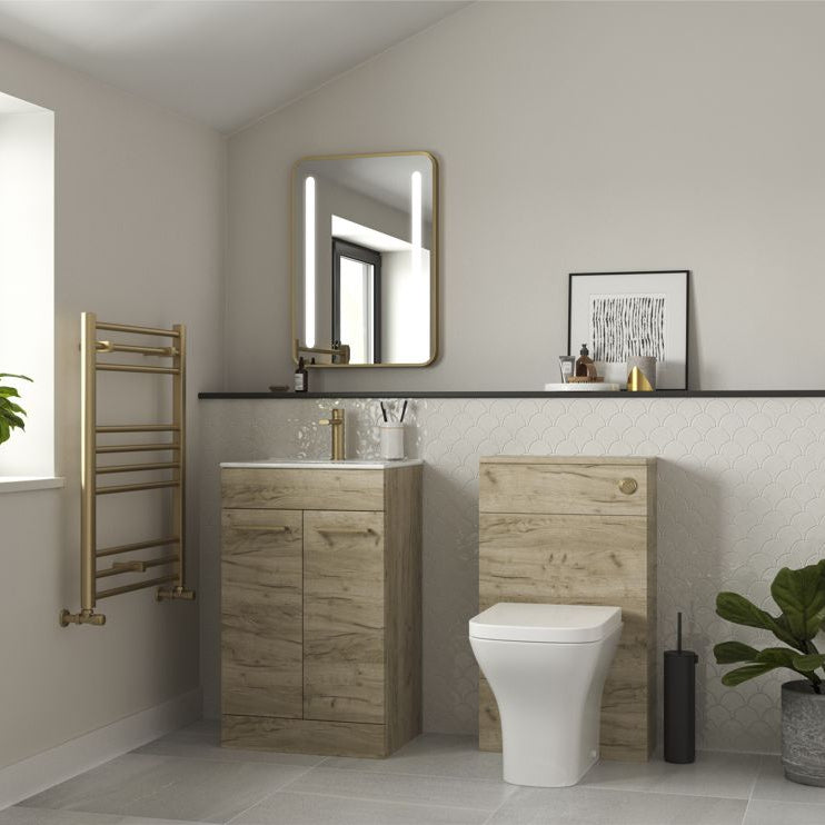 Bathroom with wooden vanity, toilet, and decorative elements.