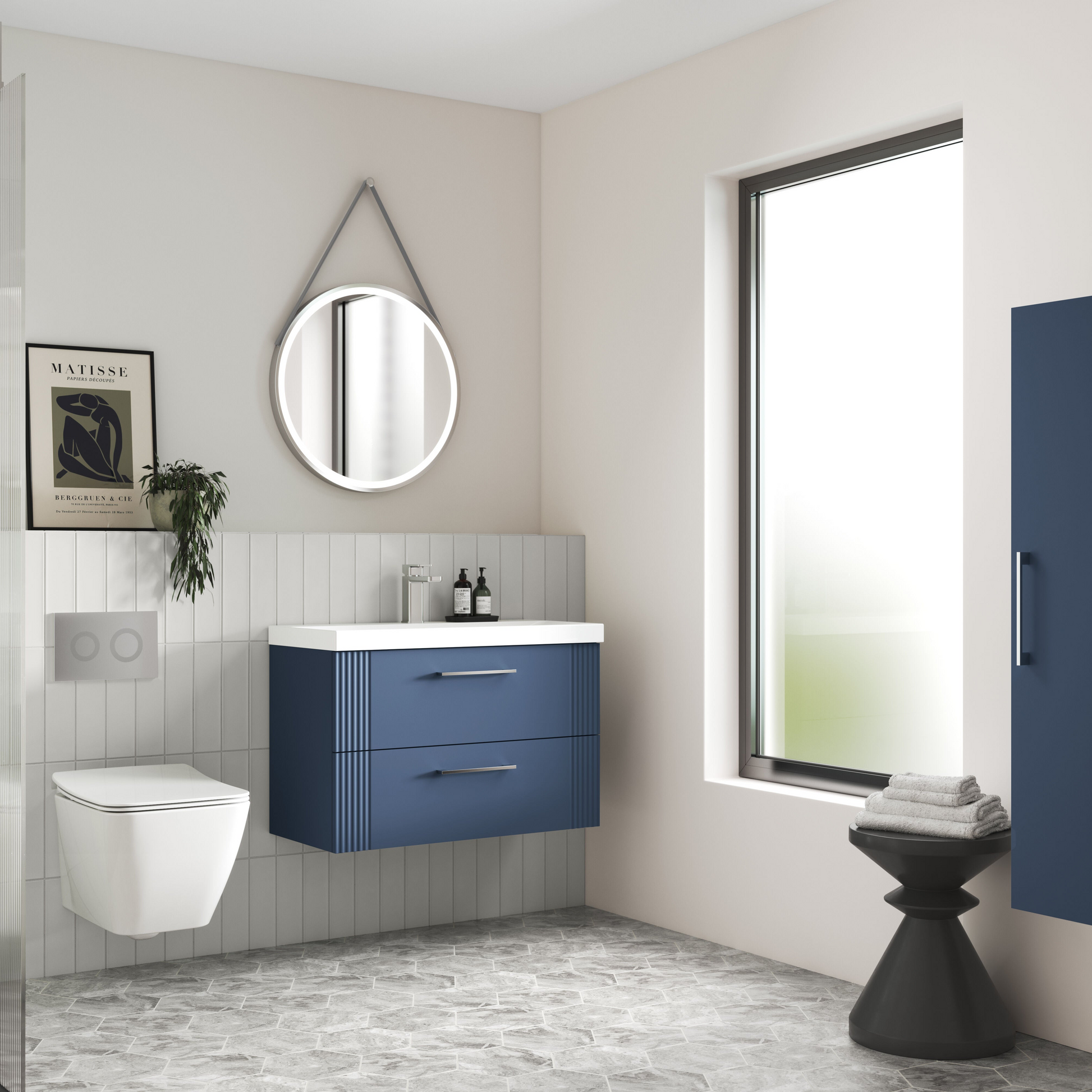 Modern bathroom with blue vanity, white toilet, and large window.