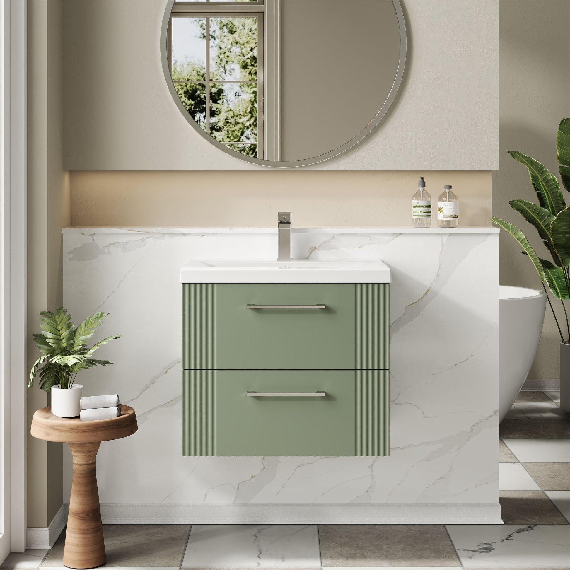 Bathroom vanity with green cabinet, white countertop, and round mirror.