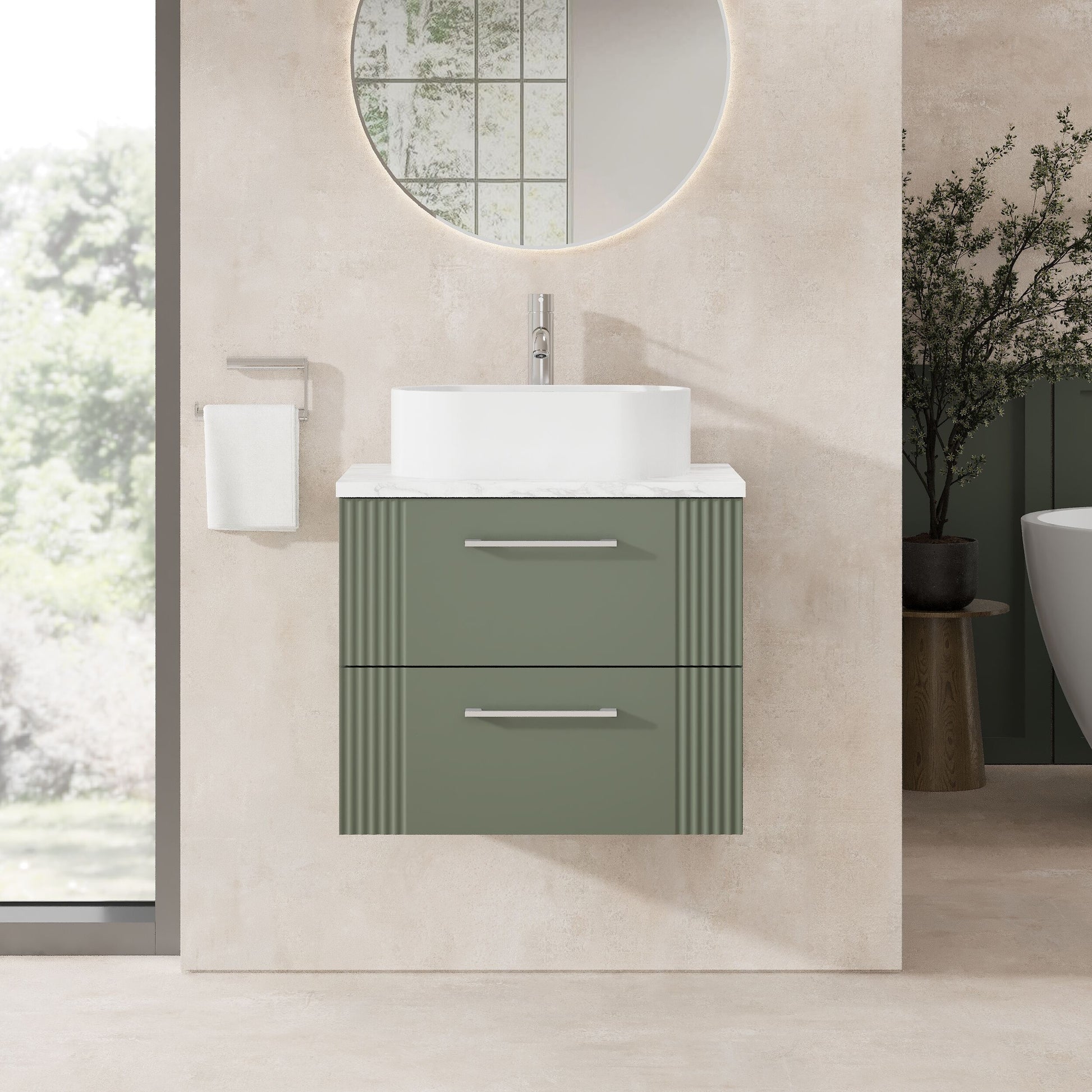 Bathroom vanity with green cabinet and white countertop in a modern bathroom setting.