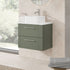 Bathroom vanity with white countertop and gray cabinet against a neutral wall.