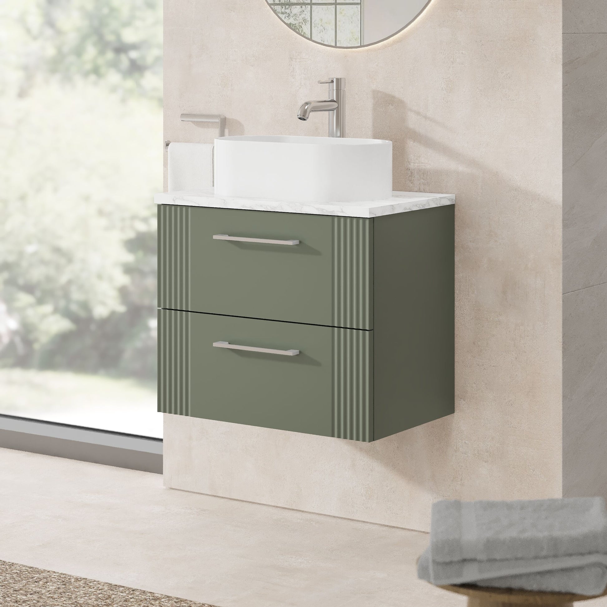 Bathroom vanity with white countertop and gray cabinet against a neutral wall.