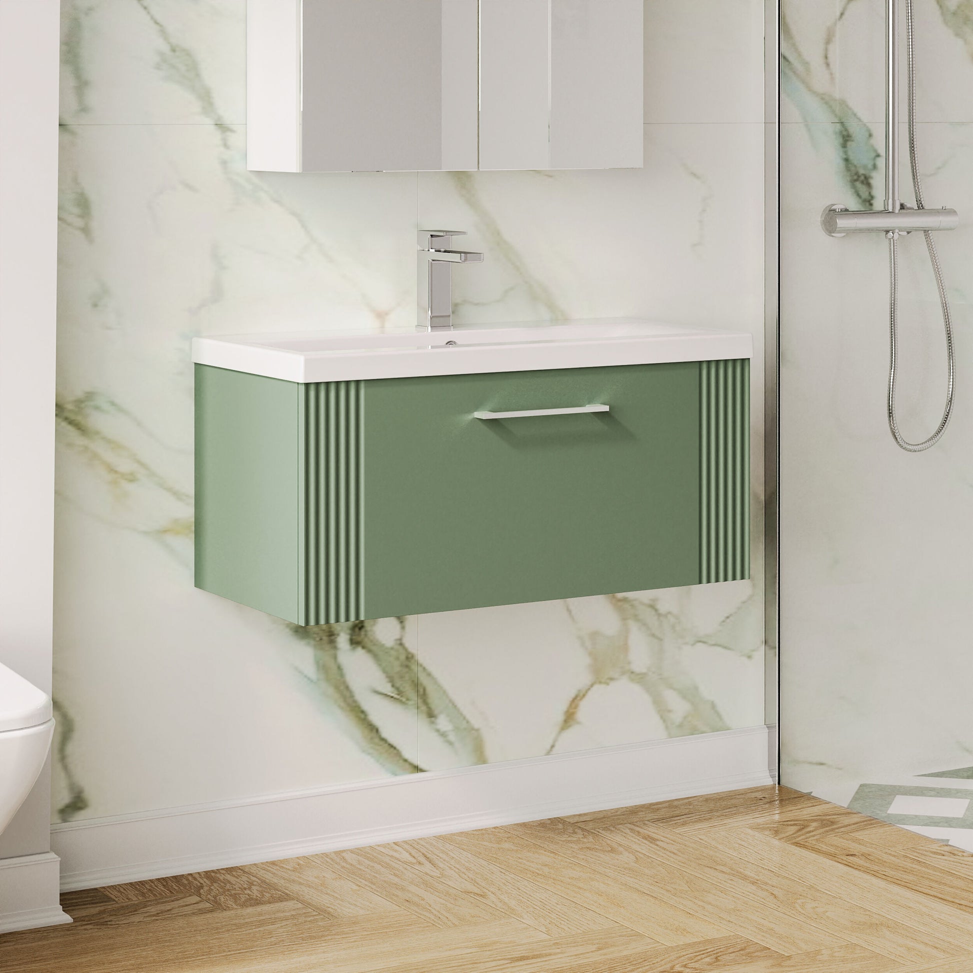 Bathroom with a green vanity unit against a marble wall.