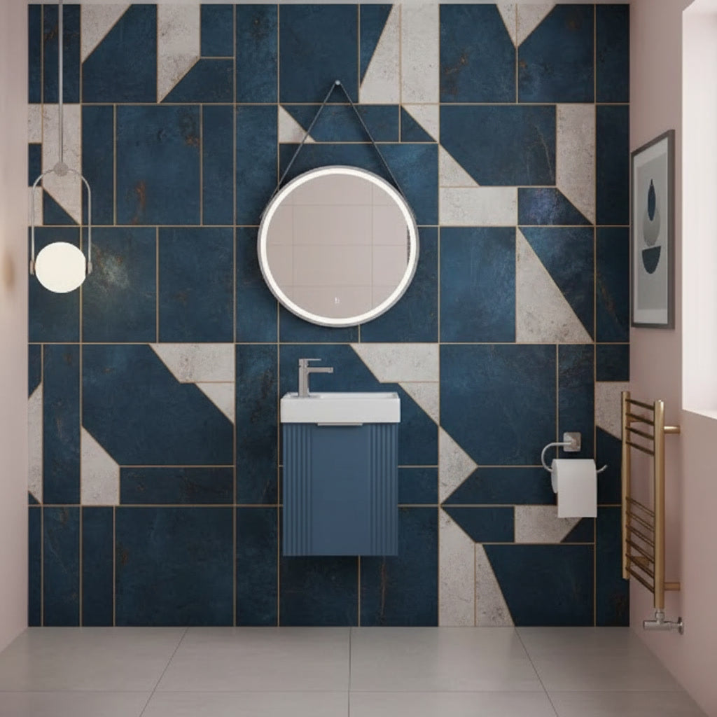 Bathroom with geometric blue and gray tile pattern, round mirror, and sink.