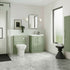 Modern bathroom with green vanity unit, white toilet, and large window.