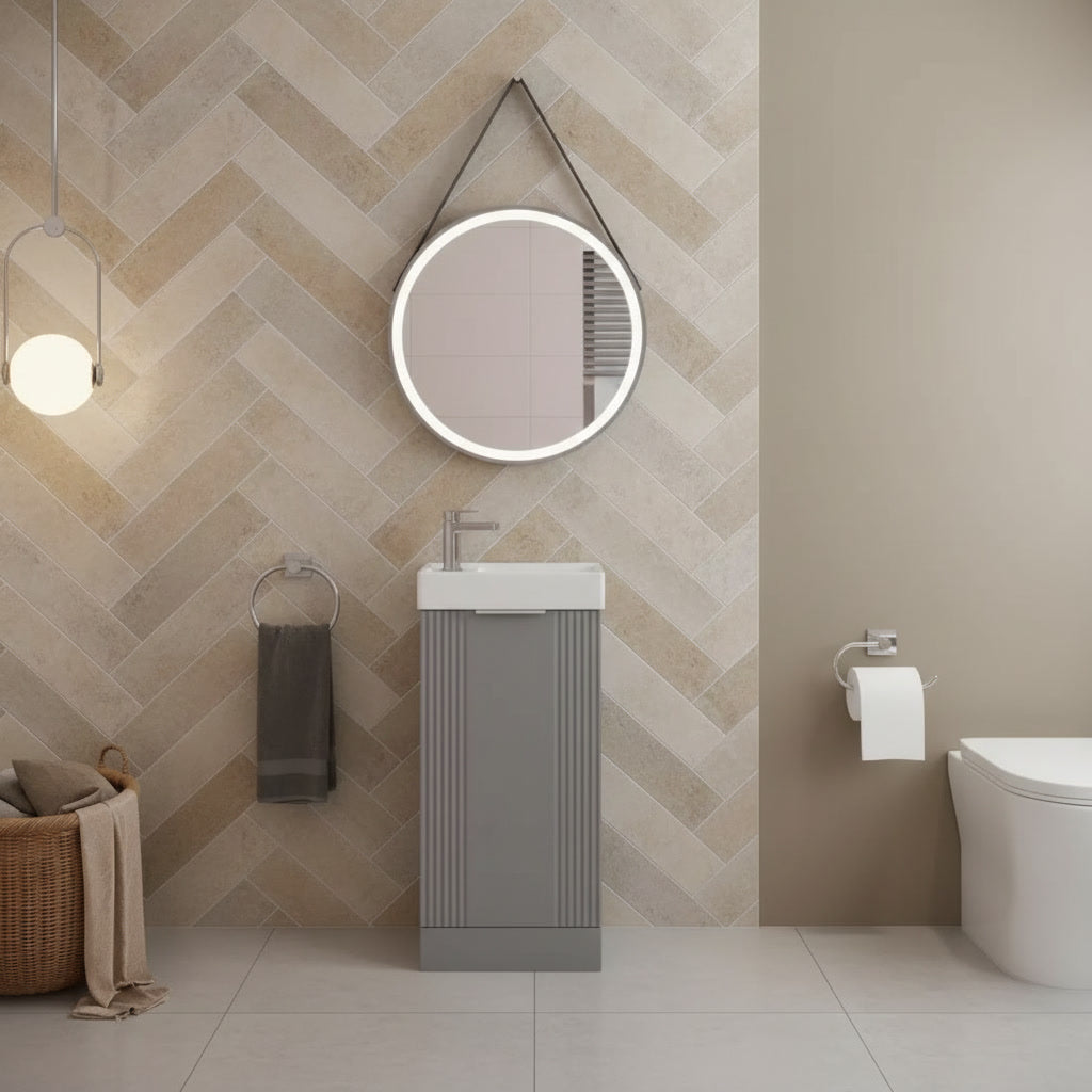 Modern bathroom with a chevron patterned wall, sink, mirror, and toilet.