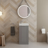 Bathroom with a chevron patterned wall, sink, mirror, and toilet.