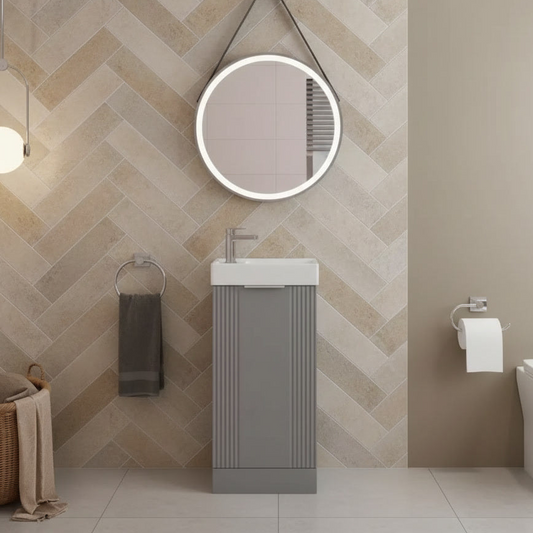 Bathroom with a chevron patterned wall, sink, mirror, and toilet.