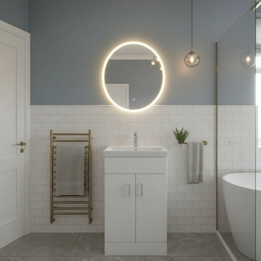 Modern bathroom with a round illuminated mirror, sink, and towel rack.