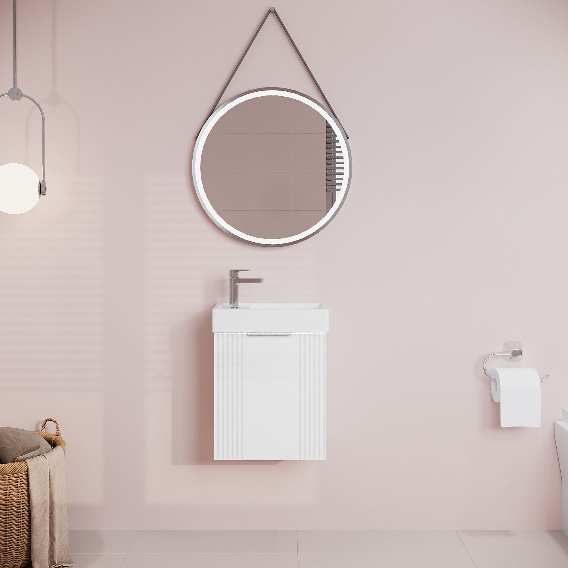 Bathroom with round mirror and white vanity against a pink wall