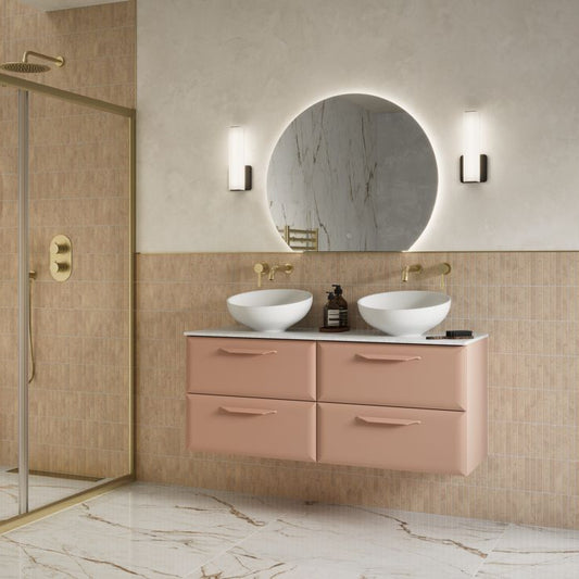 Modern bathroom with a pink vanity, half round led bathroom mirror, and shower area.