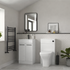Modern bathroom with white vanity, toilet, and decorative elements.