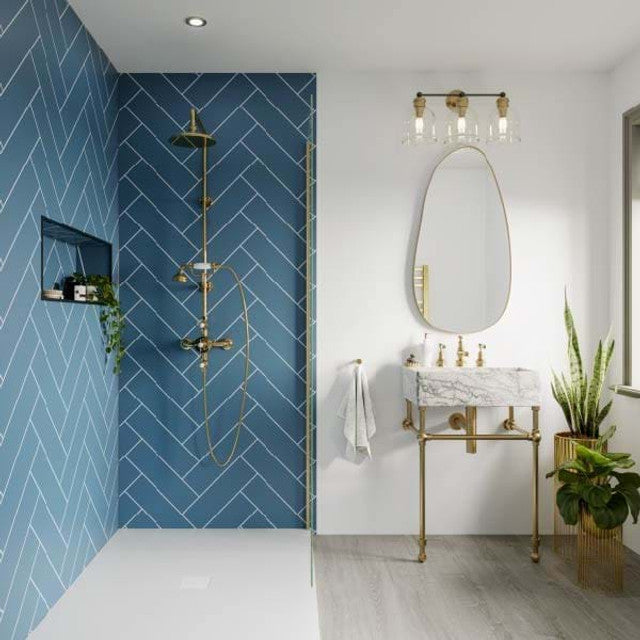 Modern bathroom with blue tiled wall, marble vanity, and gold fixtures. Multipanel Misty Blue Herringbone Tile Effect Wet Wall Shower Panel