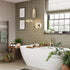 Modern bathroom with a freestanding bathtub, plants, and decorative elements. Multipanel Sage Green Metro Tile Effect Wet Wall Shower Panel