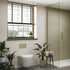 Modern bathroom with plants, a window, and a shower area. Multipanle wet wall tile effect panels. 