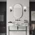 Modern bathroom with marble vanity, oval mirror, and decorative elements. Multipanel White Grey Herringbone Tile Effect Wet Wall Shower Panel