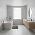Modern bathroom with onyx marble wet walls, a bathtub, sink, and mirror.