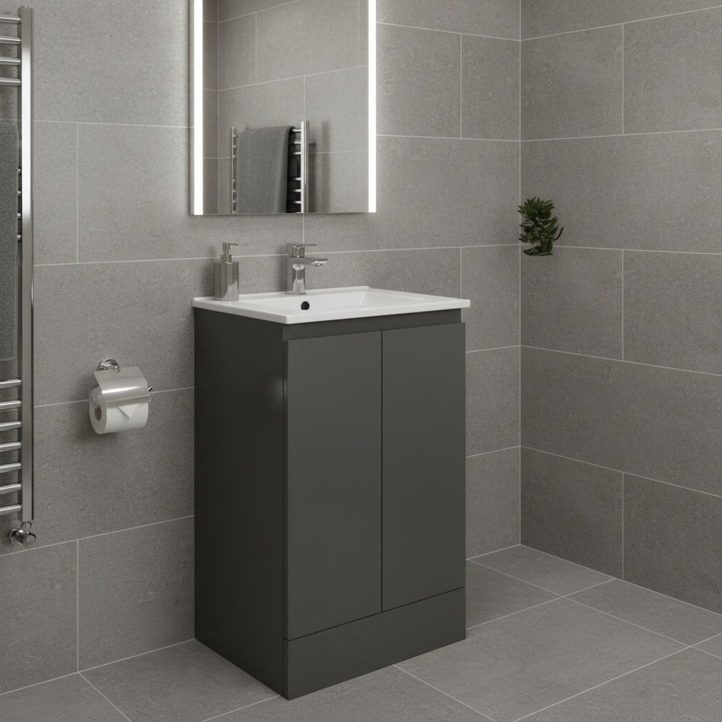 Bathroom with gray tiled walls and floor, featuring a black vanity unit with white sink.
