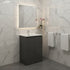 Bathroom with gray vanity, mirror, and towels on a tiled wall.