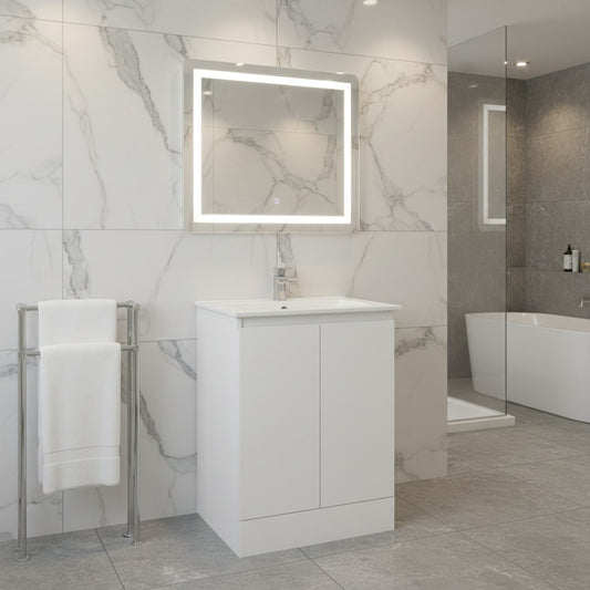 Modern bathroom with a vanity unit, illuminated mirror, and towel rack.