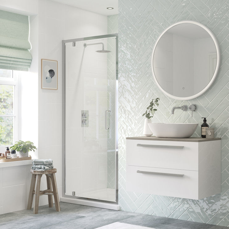 Bathroom interior with a shower, sink, and storage cabinet.