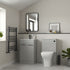Modern bathroom with gray vanity, toilet, and decorative elements.