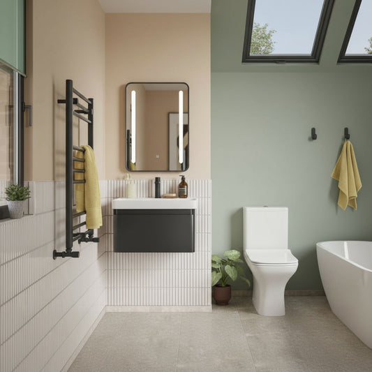 Modern bathroom with white toilet, sink, and bathtub against a green wall.