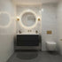 Modern bathroom interior with a floating dark vanity, illuminated round mirror, white marble-look tiled walls, wall sconces, a wall-mounted toilet, and a gray bath mat on dark floor tiles.