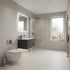 Modern bathroom with tiled walls, a sink, and a toilet.