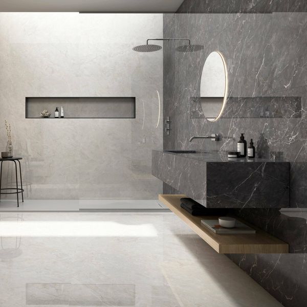 Modern bathroom with gray marble walls and a floating vanity.