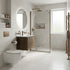 Modern bathroom with white tiles, wooden vanity, and glass shower enclosure.