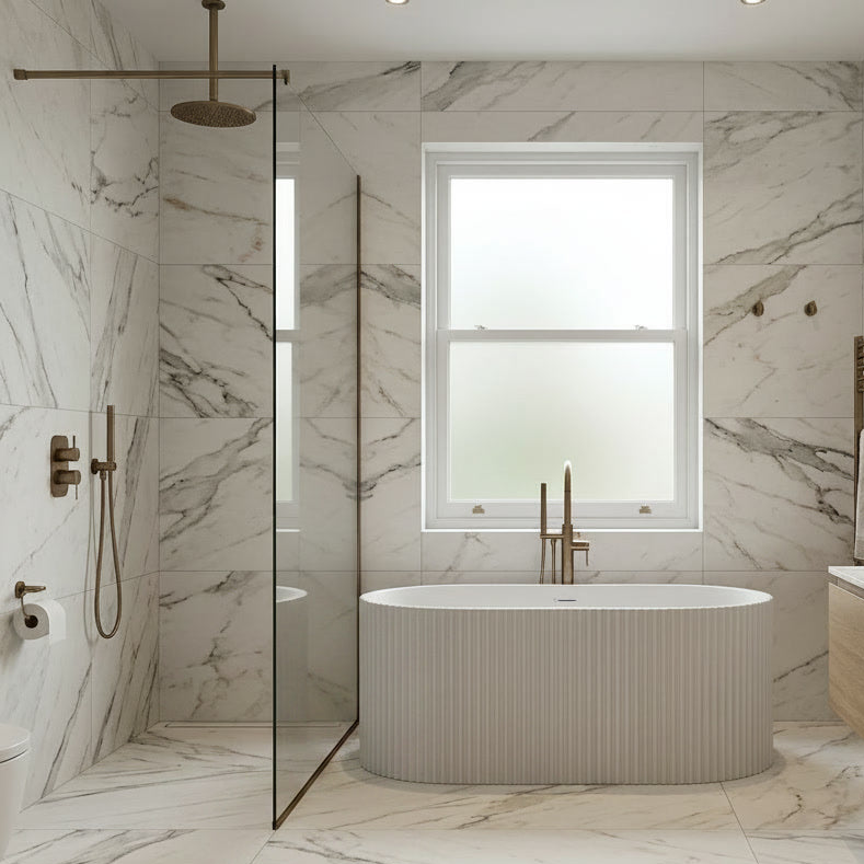 Modern bathroom with marble walls, a freestanding bathtub, and a shower area.