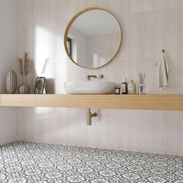 Interior wall design featuring white marble effect tiles with subtle veining, a round mirror above a white sink, and decorative items on the shelf.