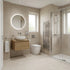 Modern bathroom with beige tiles, a round mirror, and shower area.
