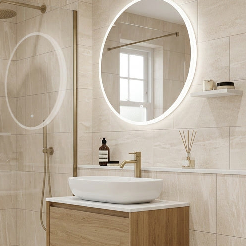 Modern bathroom with round illuminated mirror, sink, and wooden cabinet.