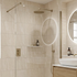 Modern bathroom with beige tiles, shower setup, and vanity area.