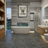 Modern bathroom with freestanding bathtub, wooden shelves, and a view of greenery outside.