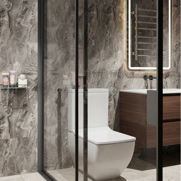 Modern bathroom with a toilet and vanity area, featuring marble walls and wooden cabinets.
